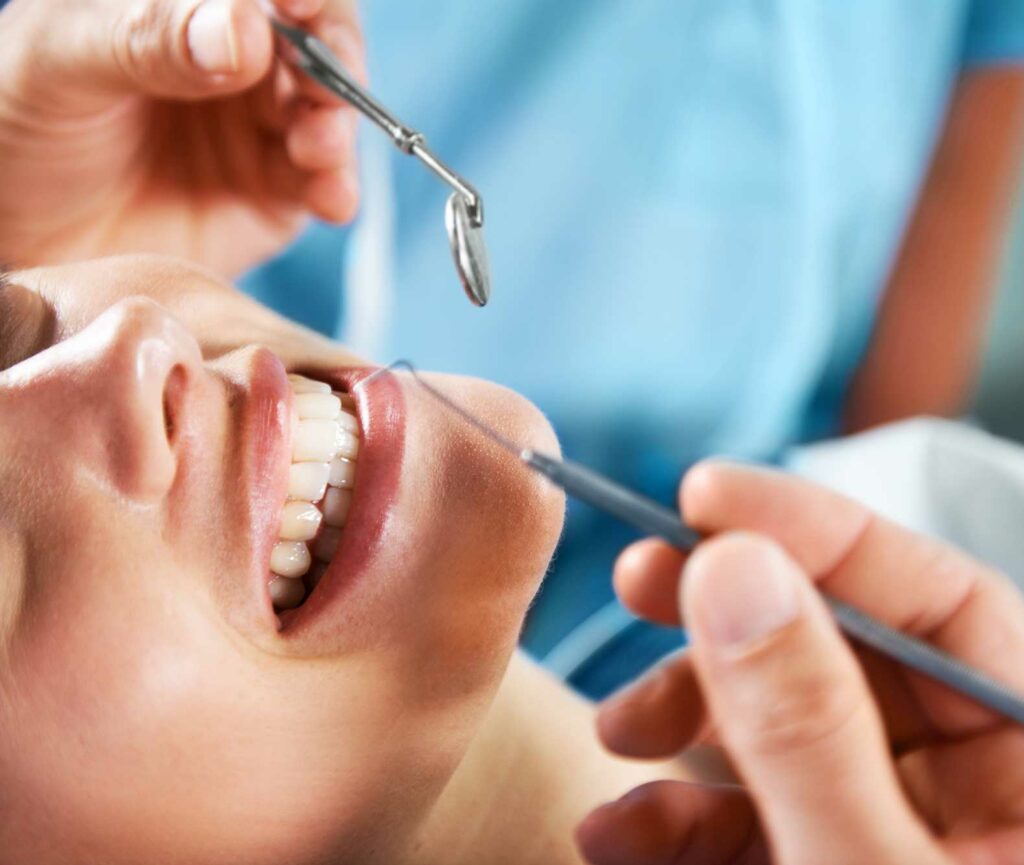 Woman having her teeth cleaned at dentist