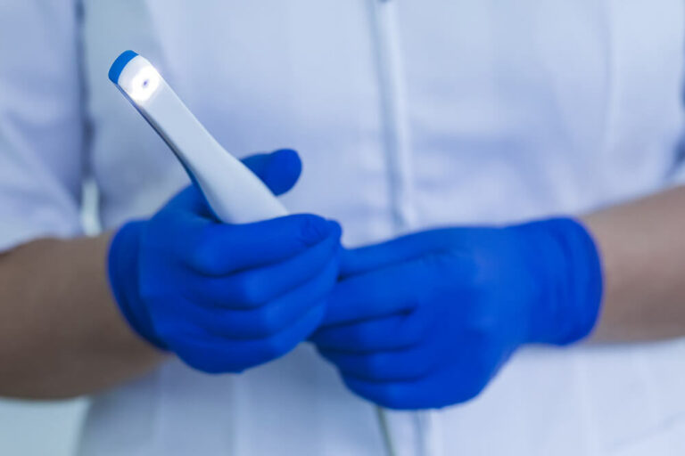 Dentist holding Intraoral Camera