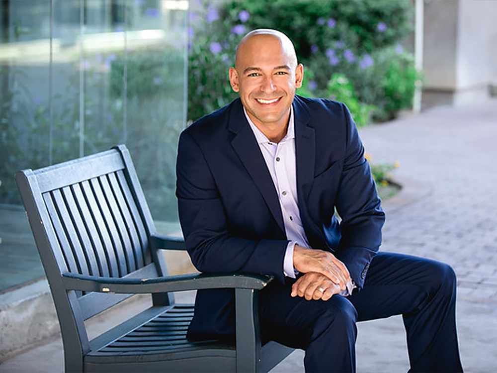 Dr. Jaime Tobon sitting on a park bench