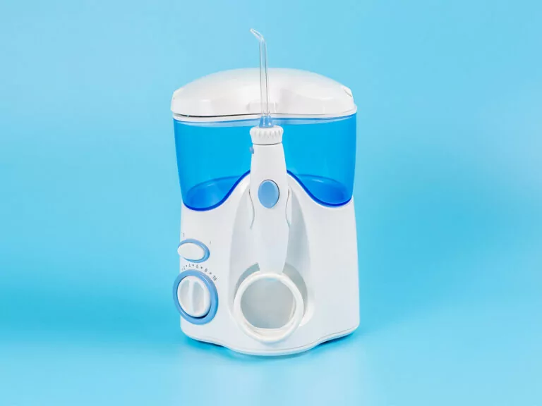 water flosser on light blue background